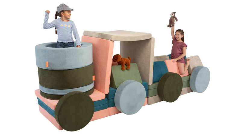Two kids play with stuffed animals inside an imaginative play furniture train engine, made of four Nuggets and two Chunks.