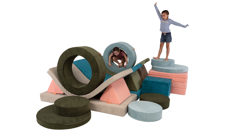 Two children play inside a four-Nugget + two-Chunk indoor obstacle course, climbing through hoops and posing atop cushions.