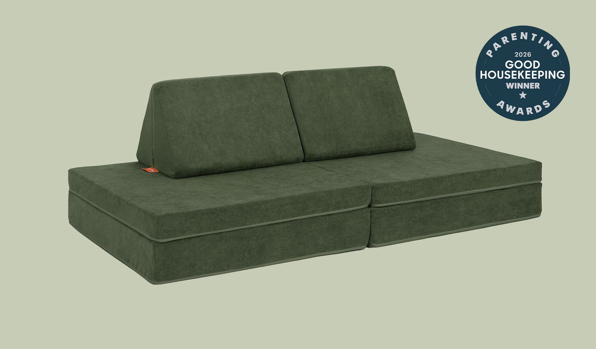 A Willow forest green Nugget play couch set up in a kids' sofa configuration.