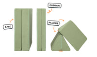 Four pieces of a mossy sage Nugget play couch lined up: one foldable base, one foldable cushion, and two triangular pillows.