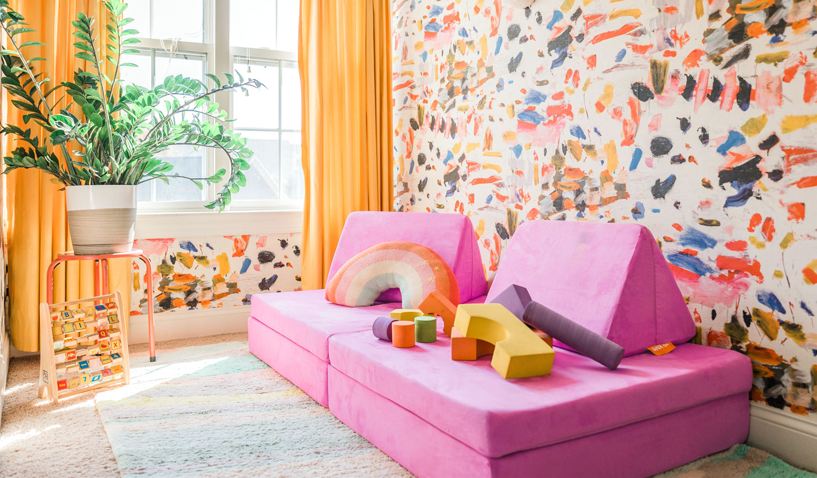 Lolly Nugget® sitting in a colorful room