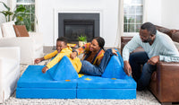 Two parents play with their child on a Neptune cobalt blue play couch by Nugget.