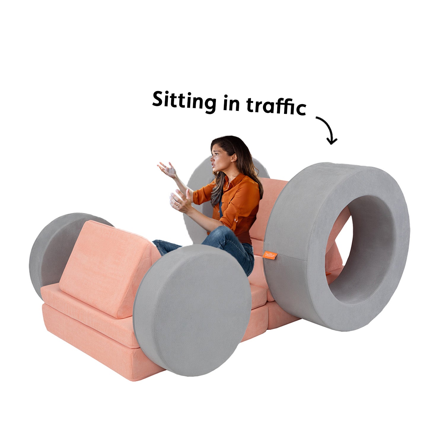 A grownup looks frustrated while pretending to be stuck in traffic in a pretend car made of a Nugget and Chunk.