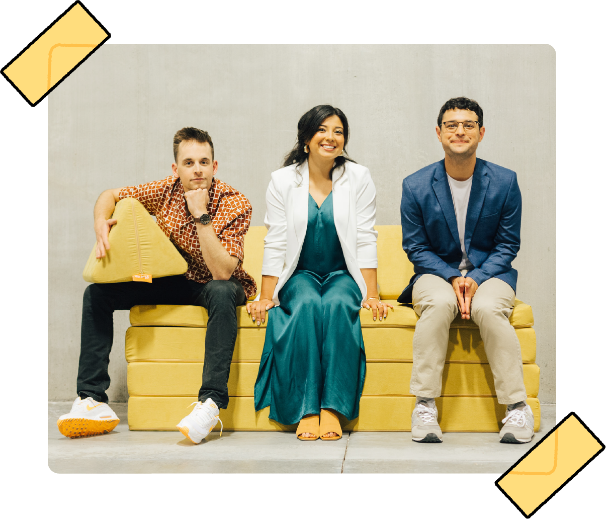 Nugget Comfort co-founders Ryan Cocca, Hannah Cocca, and David Baron pose for a photo on a yellow Nugget play couch.