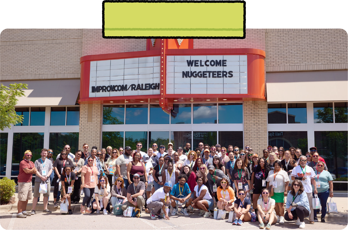 Employees of Nugget Comfort pose for a photo together in front of a marquee that says “Welcome Nuggeteers.”