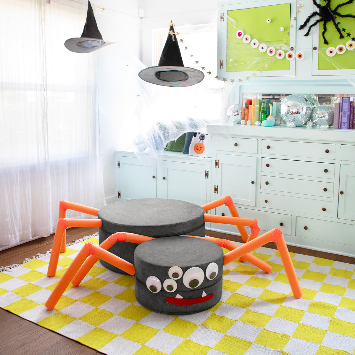 A dark gray Chunk is arranged with accessories to resemble a giant spider with googly eyes.