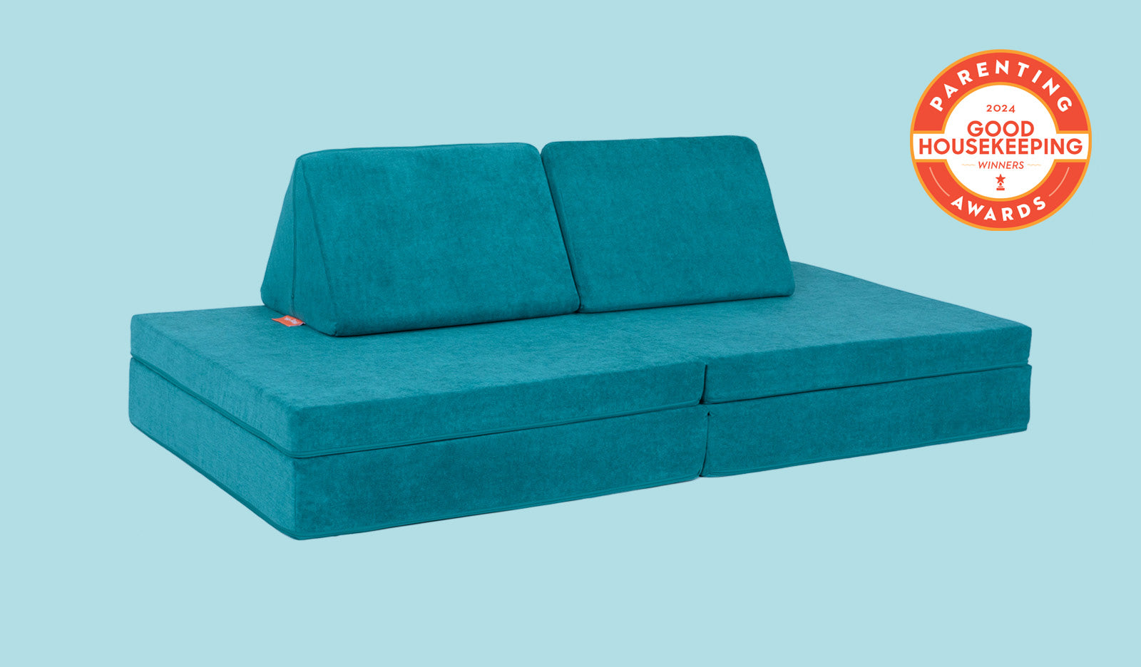 An Atlantis peacock teal Nugget play couch set up in a kids' sofa configuration.