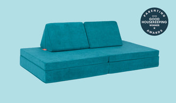 An Atlantis peacock teal Nugget play couch set up in a kids' sofa configuration.