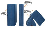 Four pieces of a navy blue Nugget play couch lined up: one foldable base, one foldable cushion, and two triangular pillows.