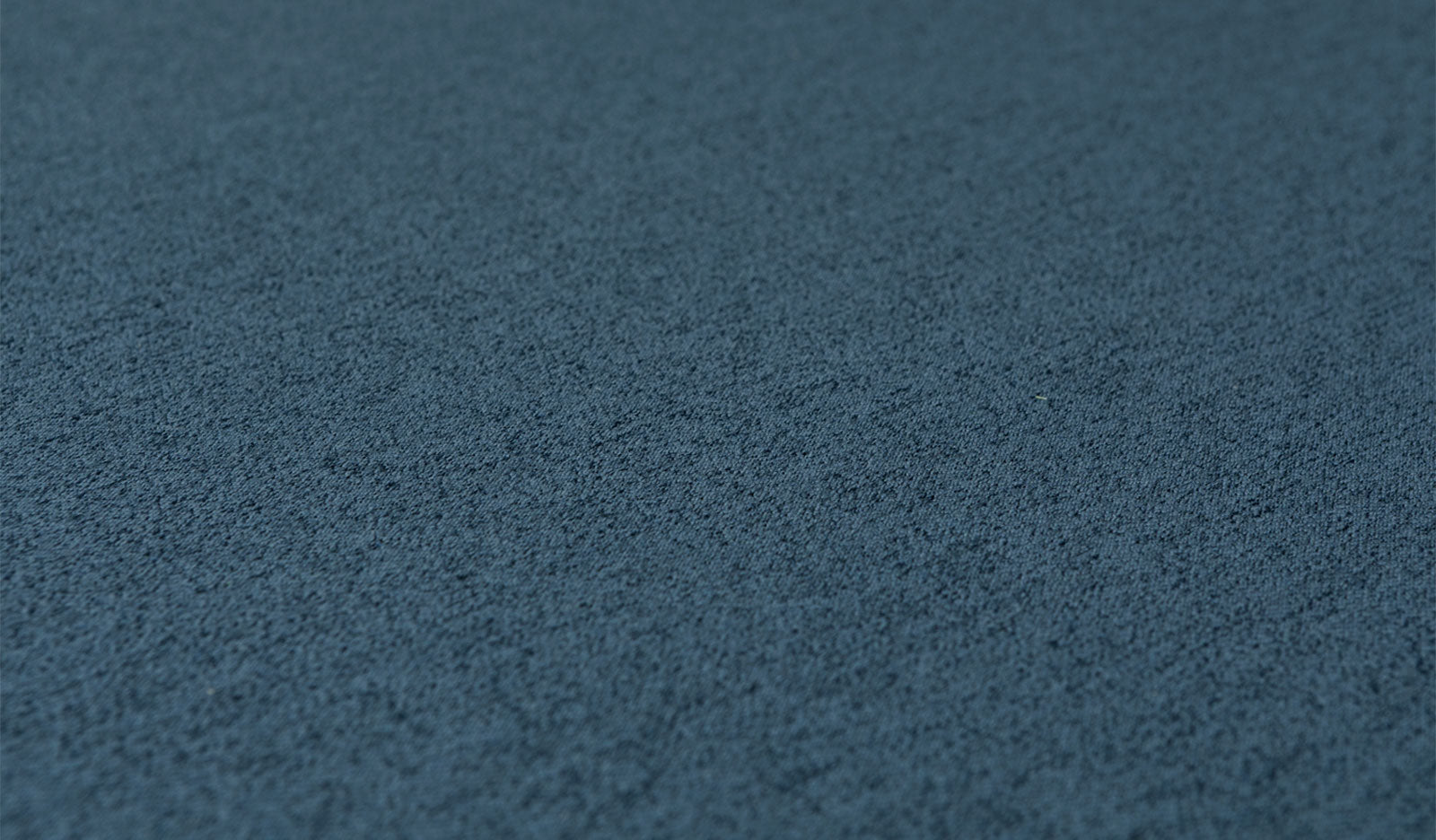 Close-up of the luxe texture of Nugget's double-brushed microsuede fabric in dark-wash denim Buckaroo.