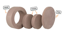 Four pieces of an earthy taupe Chunk play ottoman lined up: one large hoop, two sturdy nesting, and one wider pad for the lid.
