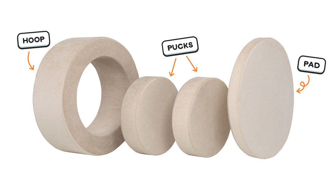 Four pieces of a vintage beige Chunk play ottoman lined up: one large hoop, two sturdy nesting, and one wider pad for the lid.