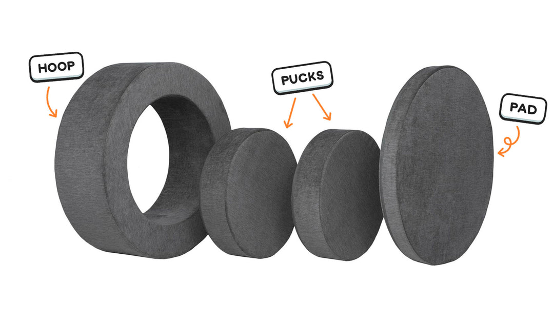 Four pieces of a charcoal gray Chunk play ottoman lined up: one large hoop, two sturdy nesting, and one wider pad for the lid.