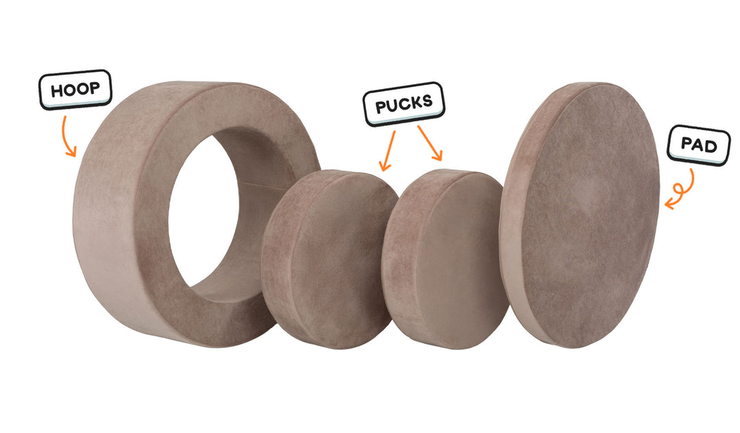 Four pieces of an earthy taupe Chunk play ottoman lined up: one large hoop, two sturdy nesting, and one wider pad for the lid.