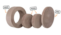 Four pieces of an earthy taupe Chunk play ottoman lined up: one large hoop, two sturdy nesting, and one wider pad for the lid.
