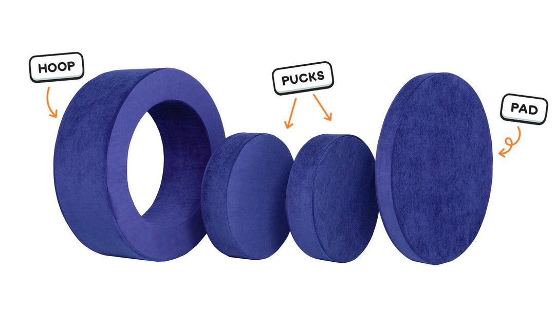 Four pieces of a vibrant indigo Chunk play ottoman lined up: one large hoop, two sturdy nesting, and one wider pad for the lid.