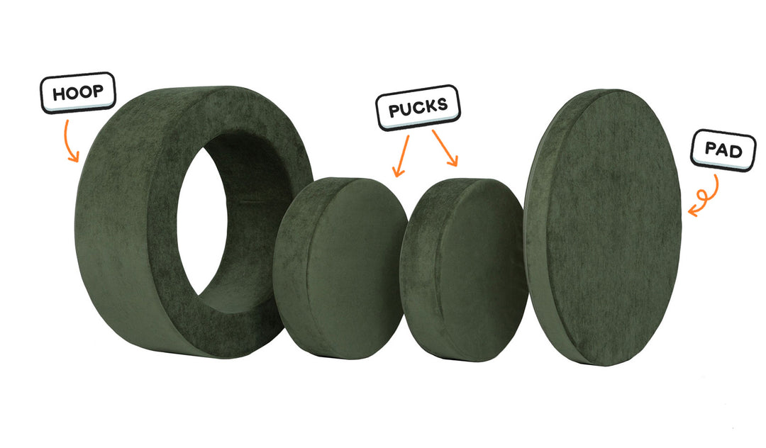 Four pieces of a forest green Chunk play ottoman lined up: one large hoop, two sturdy nesting, and one wider pad for the lid.