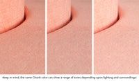 Close-up of a Chunk puck in Blossom light peach across three lighting situations. One color can present as a range of tones depending on the room.