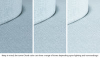 Close-up of a Chunk puck in Surfside light gray-blue across three lighting situations. One color can present as a range of tones depending on the room.