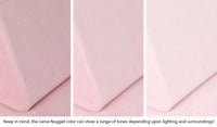 Close-up of a Nugget pillow in Heartthrob blush pink across three lighting situations. One color can present as a range of tones depending on the room.