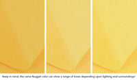 Close-up of a Nugget pillow in Lemonade classic yellow across three lighting situations. One color can present as a range of tones depending on the room.