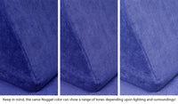 Close-up of a Nugget pillow in Nebula vibrant indigo across three lighting situations. One color can present as a range of tones depending on the room.