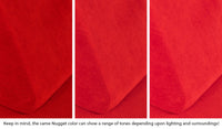 Close-up of a Nugget pillow in Trolley true red across three lighting situations. One color can present as a range of tones depending on the room.