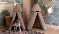 A child crawls through a tunnel created by the tented taupe pieces of a Cottontail Nugget play couch.