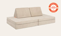 A Dunebuggy vintage beige Nugget play couch set up in a kids' sofa configuration.