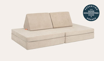 A Dunebuggy vintage beige Nugget play couch set up in a kids' sofa configuration.