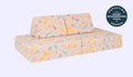 A whimsical unicorn-patterned Nugget play couch set up in a kids' sofa configuration.