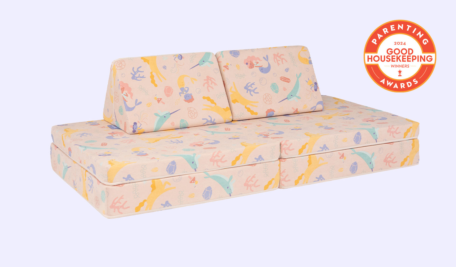 A whimsical unicorn-patterned Nugget play couch set up in a kids' sofa configuration.