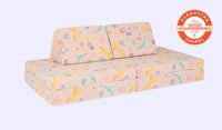 A whimsical unicorn-patterned Nugget play couch set up in a kids' sofa configuration.