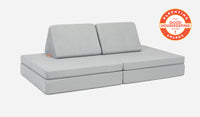 A Koala light gray Nugget play couch set up in a kids' sofa configuration.