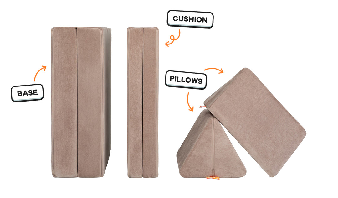 Four pieces of an earthy taupe Nugget play couch lined up one foldable base one foldable cushion and two triangular pillows.