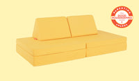 A Lemonade classic yellow Nugget play couch set up in a kids' sofa configuration.