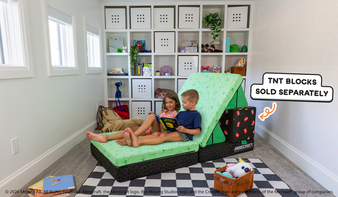 Two children read a book while seated on the Minecraft Nugget and Minecraft TNT Blocks by Nugget. A graphic note reads, "TNT Blocks sold separately."