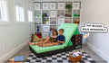Two children read a book while seated on the Minecraft Nugget and Minecraft TNT Blocks by Nugget. A graphic note reads, "TNT Blocks sold separately."