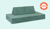 A Seamonster sea green Nugget play couch set up in a kids' sofa configuration.