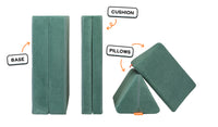 Four pieces of a sea green Nugget play couch lined up: one foldable base, one foldable cushion, and two triangular pillows.