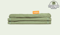 A neatly folded and stacked Smore Cover Set in mossy sage Bamboo.