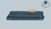 A neatly folded and stacked Smore Cover Set in dark-wash denim Buckaroo.