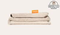 A neatly folded and stacked Smore Cover Set in vintage beige Dunebuggy.