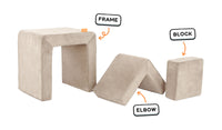 Four pieces of a vintage beige Smore play chair lined up: sturdy frame, one L-shaped elbow, and one square block.