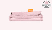 A neatly folded and stacked Smore Cover Set in blush pink Heartthrob.