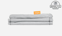 A neatly folded and stacked Smore Cover Set in light gray Koala.