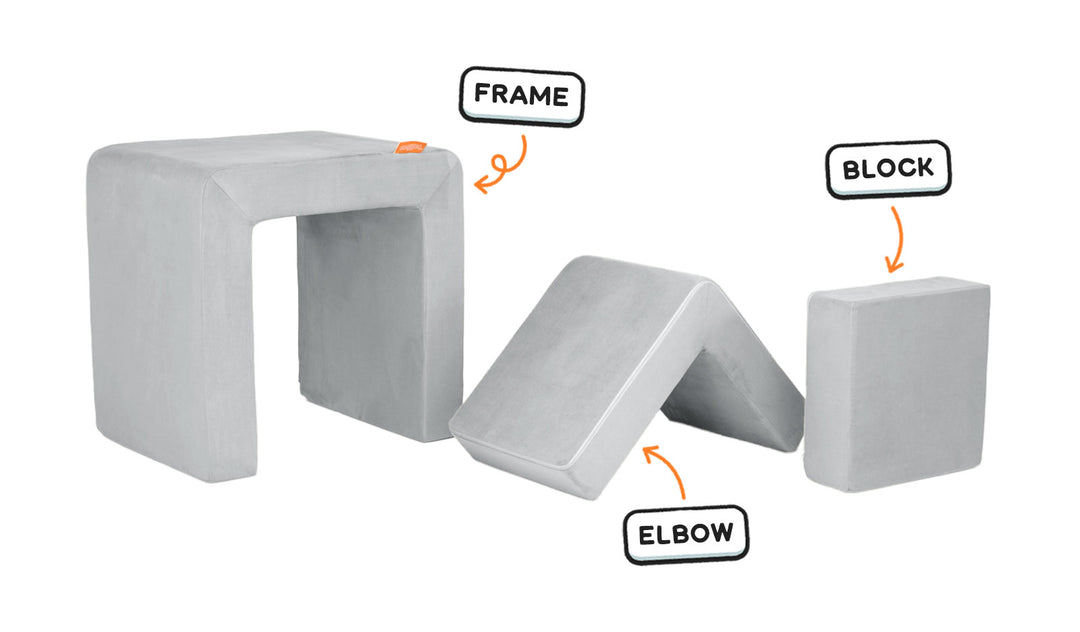 Four pieces of a light gray Smore play chair lined up: sturdy frame, one L-shaped elbow, and one square block.