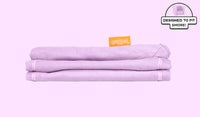 A neatly folded and stacked Smore Cover Set in lilac purple Moonshot.  