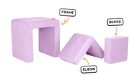 Four pieces of a lilac purple Smore play chair lined up: sturdy frame, one L-shaped elbow, and one square block.