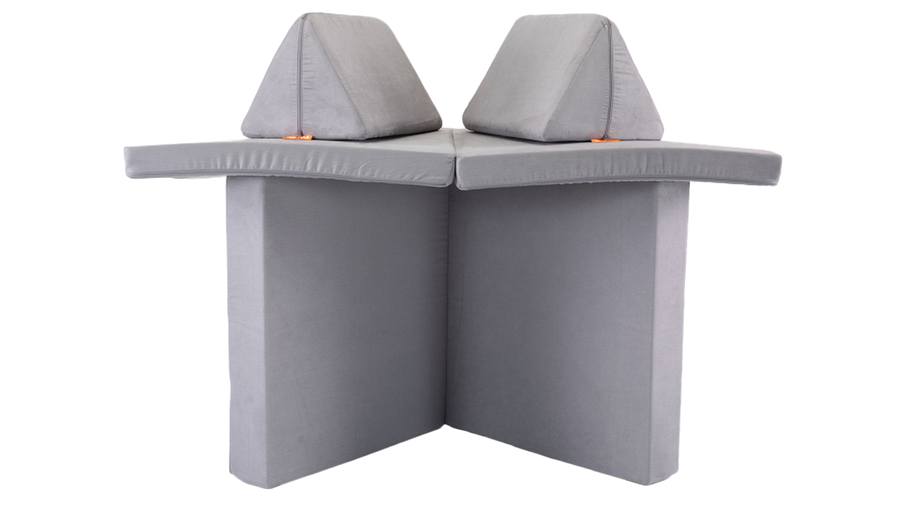 One light gray Nugget play couch forms a cozy shelter build, ready for imaginative play.